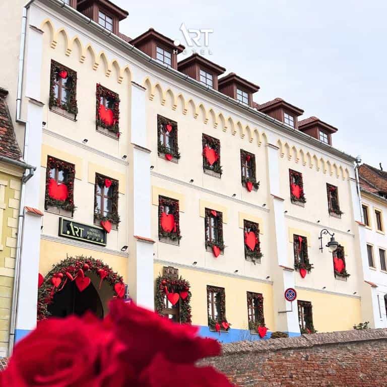 Art Hotel Sibu facade decorated with red hearts for Valentine's Day, red roses foreground
