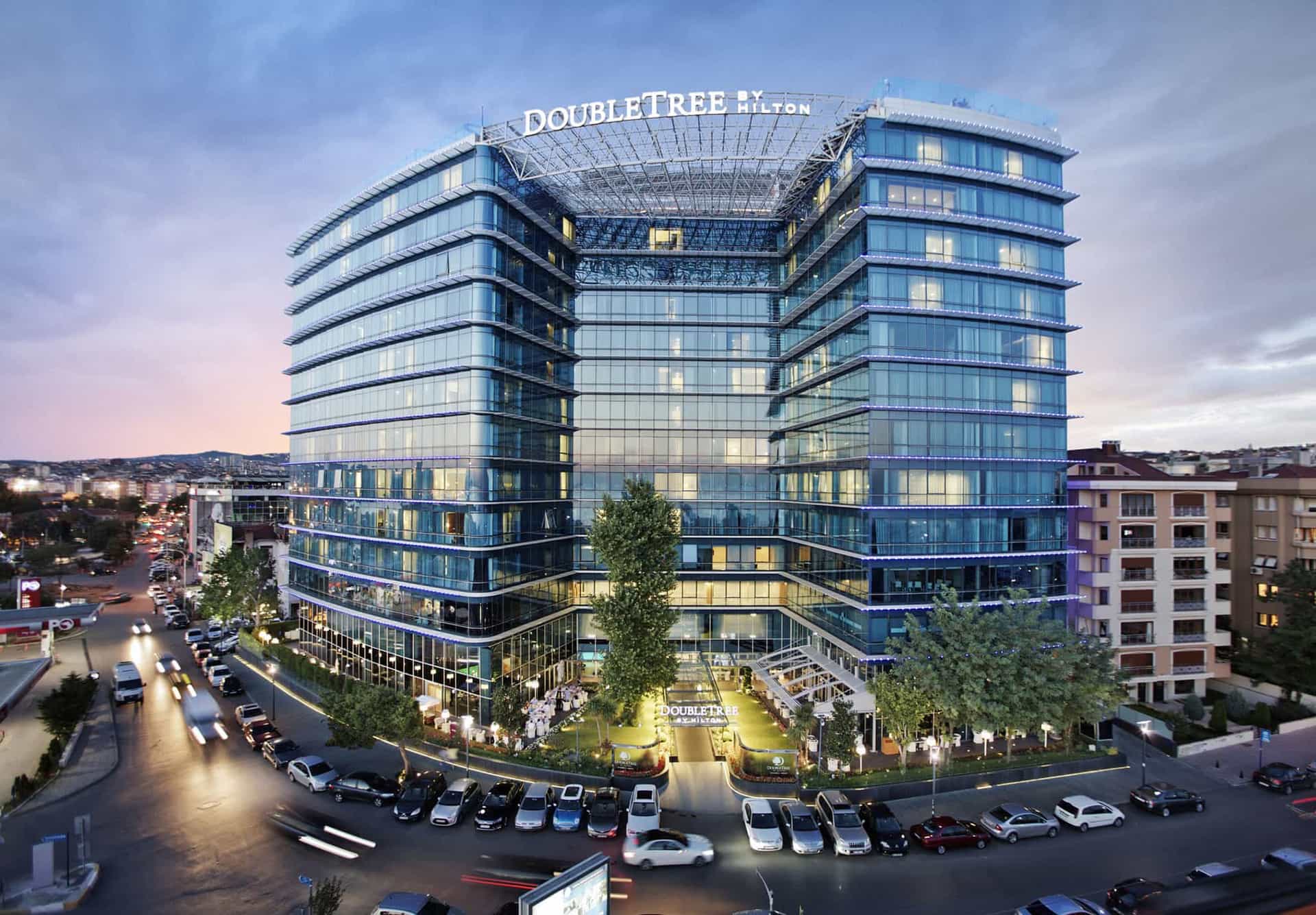 DoubleTree by Hilton hotel exterior at dusk with traffic motion blur in Zagreb.