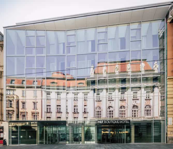 MET Boutique Hotel modern glass facade reflecting historic European architecture in Zagreb.