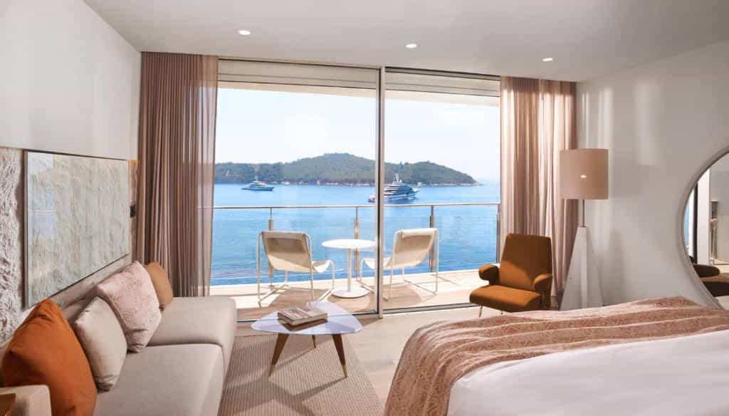 Hotel room with balcony overlooking blue sea, islands, and yachts, likely Dubrovnik.