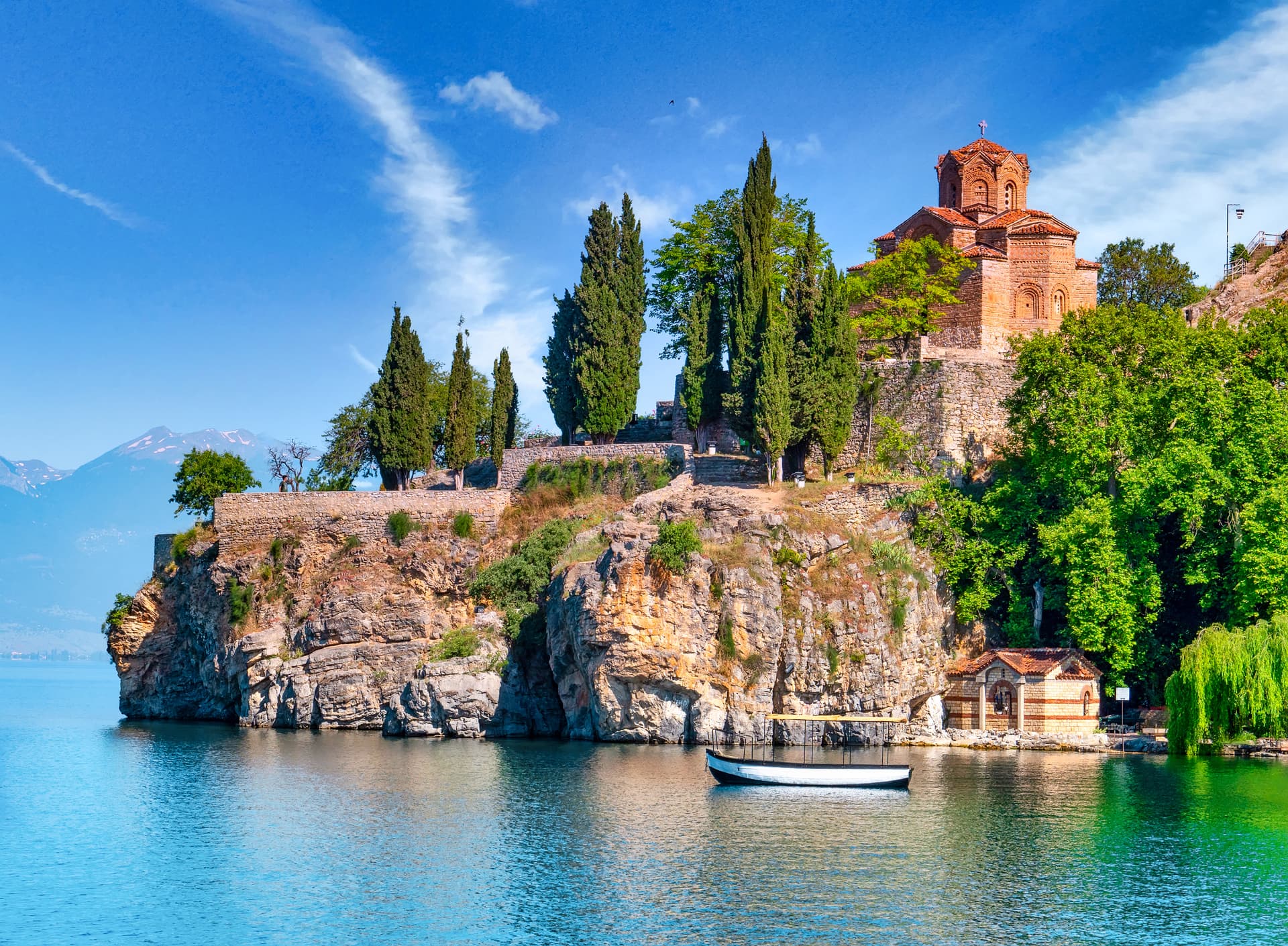 Church of St. John at Kaneo on cliff above Ohrid Lake with boat below