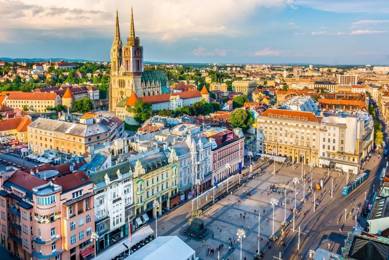 Zagreb panorama showing the Cathedral and Ban Jelačić Square with a tram.