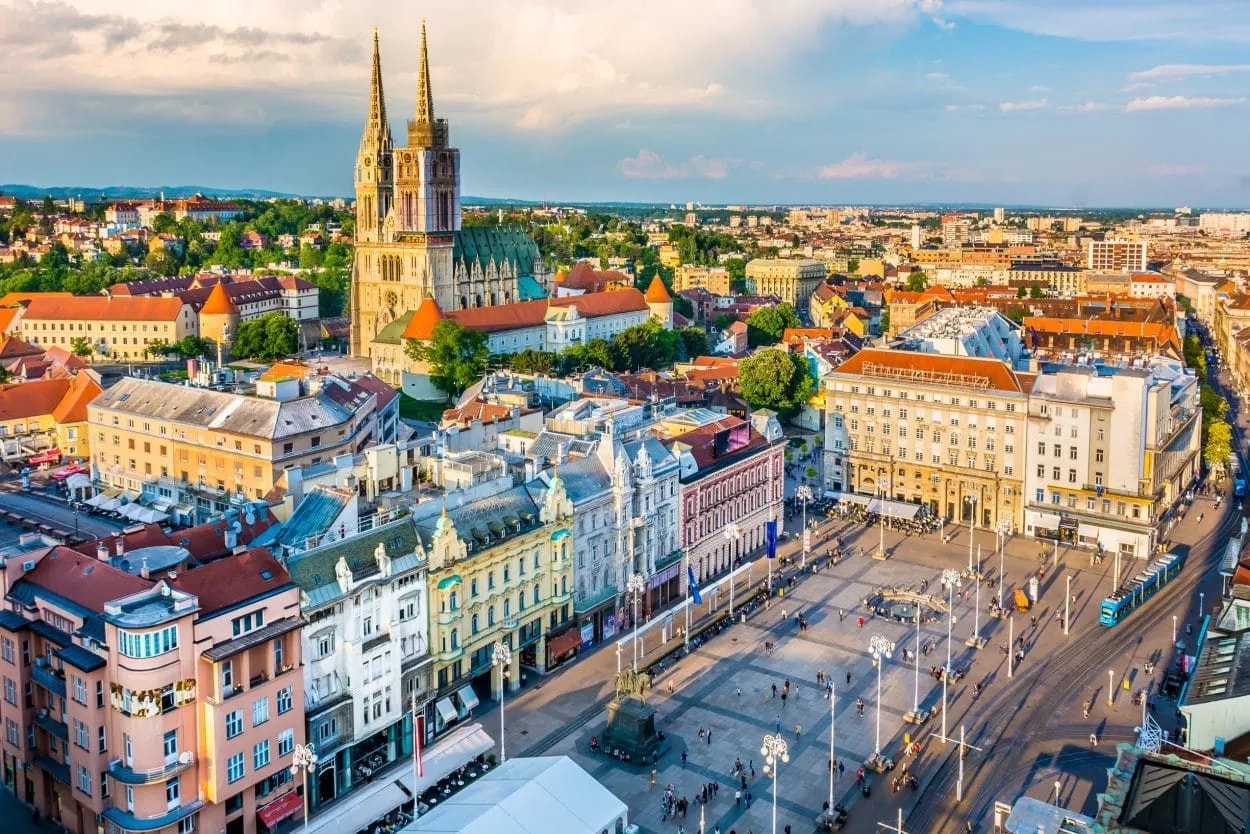 Zagreb panorama with cathedral spires overlooking city square and historic buildings.