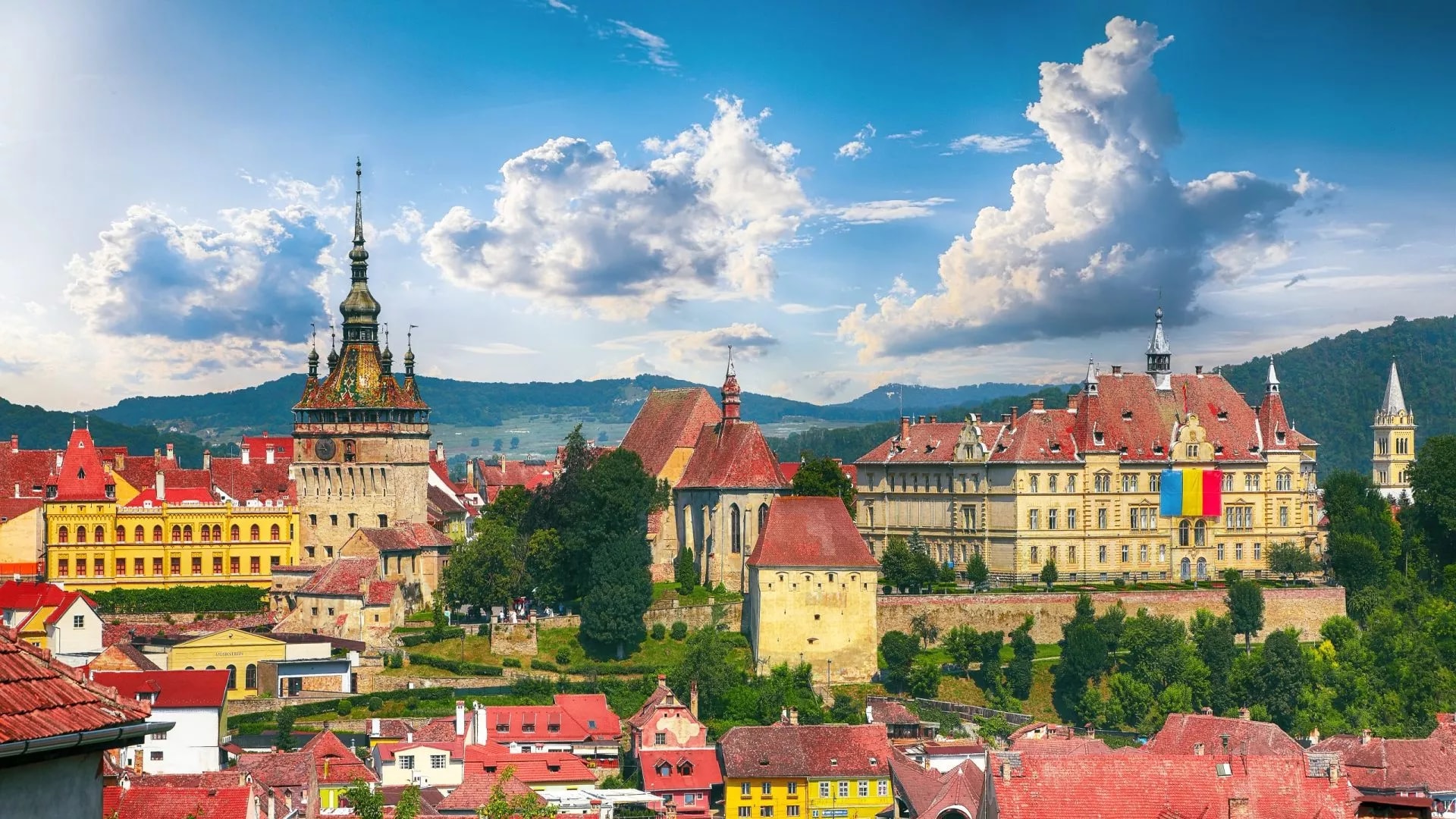Panoramic view over the architecture in Sighisoara town with Clock Tower and colorful roofs.