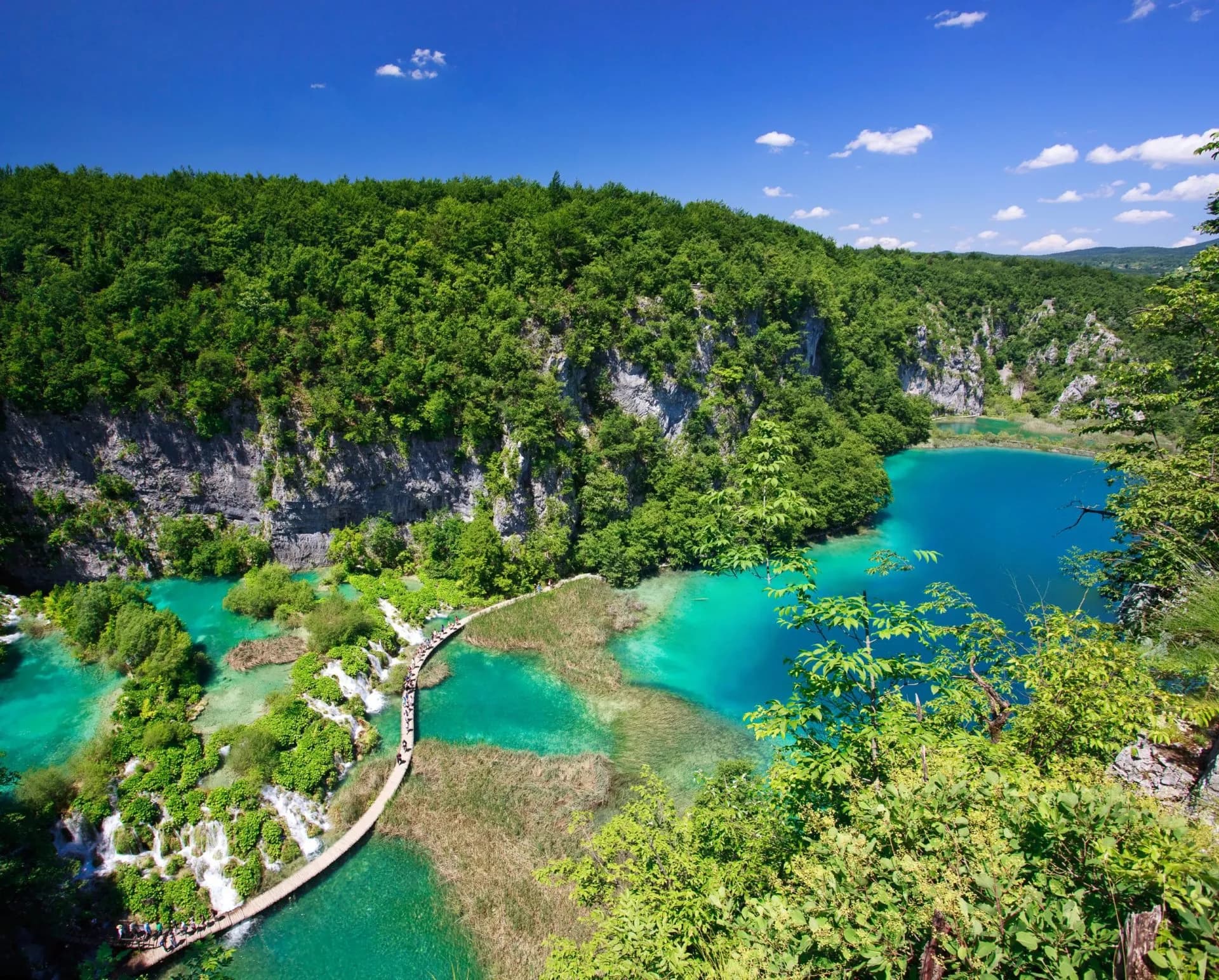 Plitvice Lakes National Park Croatia boardwalk over turquoise pools surrounded by lush green forest