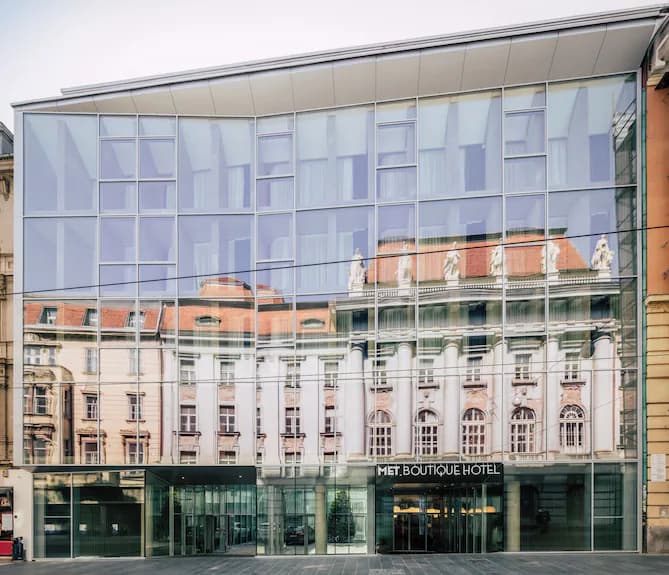 MET Boutique Hotel modern glass facade reflecting historic European architecture in Zagreb.